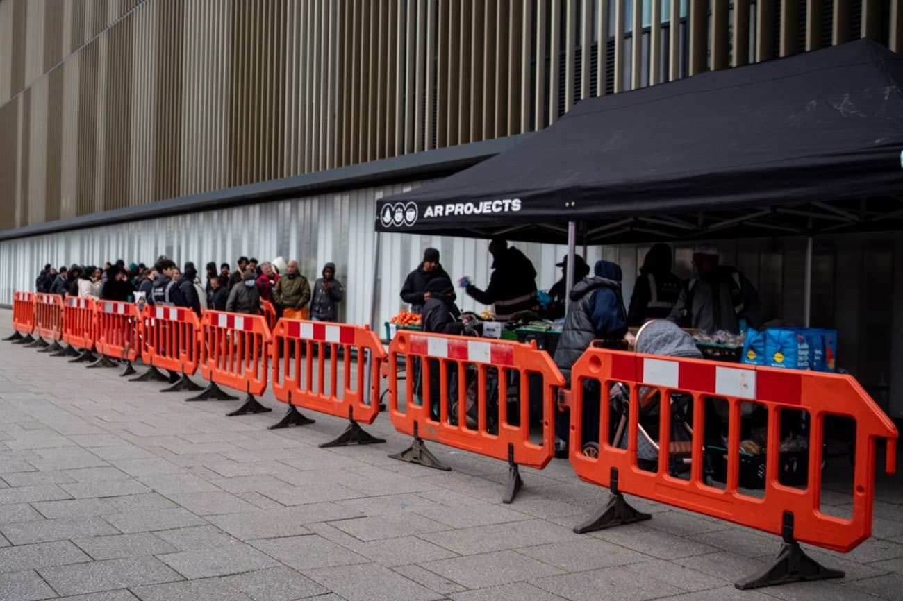 People gathering at the AR Projects gazebo for a hot meal