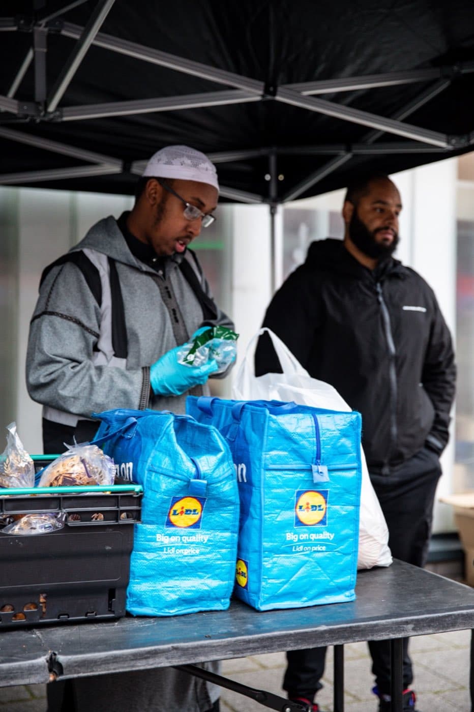 Volunteers serving hot meals at the AR Projects soup kitchen